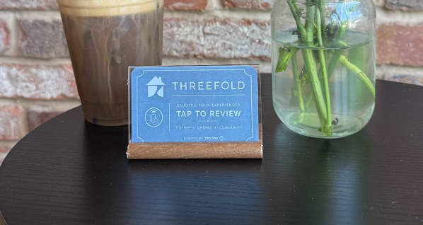 Tap-Tap NFC review sign on a table at Threefold cafe